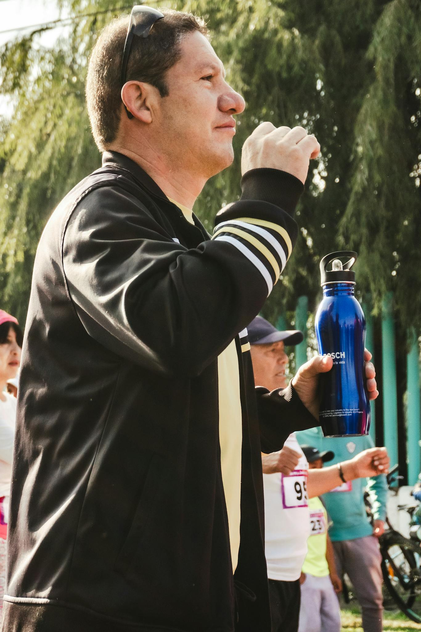 A man holding a water bottle while running
